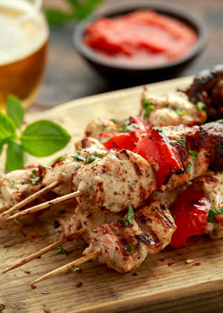 Chicken kebab, BBQ, skewers with mushrooms, red sweet pepper, zucchini and beer. Party food.の写真素材
