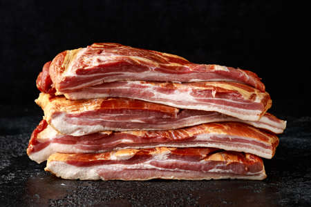 Stripy cured pork side bacon pancetta smoked on wood chipの写真素材