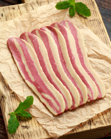 Raw plant based vegan Bacon pieces on crumpled paperの写真素材