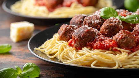 Vegetarian spaghetti with meat free, vegan meatballs in rich tomato sauce, grated cheese and basil leavesの写真素材