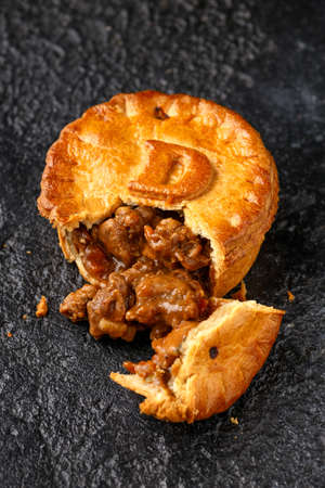 British duck pie on rustic dark background
