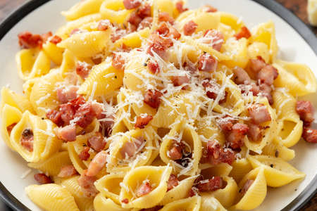Classic Pasta carbonara with bacon, egg, cream, black pepper and Parmesan Cheese on plate. Italian foodの写真素材