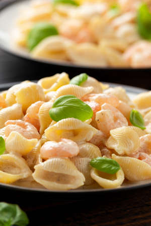 Italian conchiglie prawn, shrimp pasta in a creamy sauce on plate.の写真素材