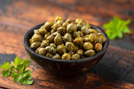 Marinated Pickled Capers in a wooden bowl