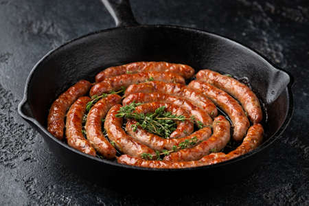 Homemade Pork Sausages in rustic pan with thymeの写真素材