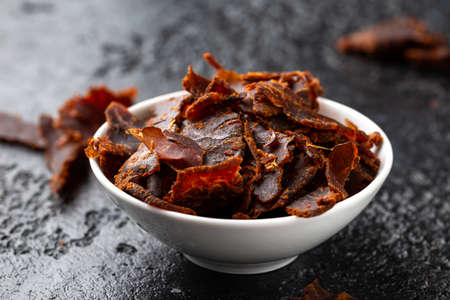 Dried Beef Jerky snack in white bowlの写真素材