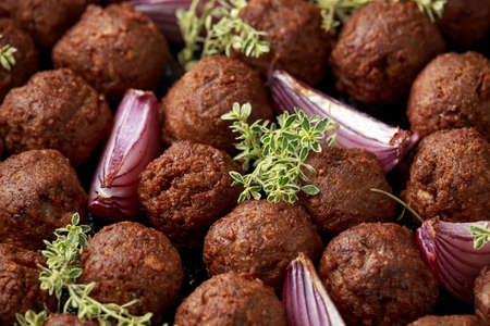 Thyme and onion vegetarian vegan meatballs oven baked in cast iron skillet frying panの写真素材