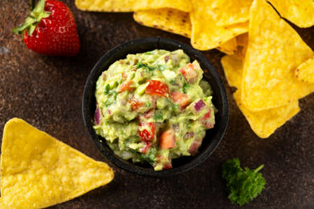 Strawberry and avocado guacamole, salsa with crispy tortilla chipsの写真素材