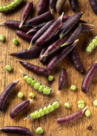 Sweet purple Magnolia Pea, Sugarsnap on rustic wooden board. ready to eatの写真素材