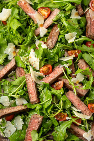 Italian Beef Tagliata salad with wild rocket, cherry tomatoes and parmesan cheeseの写真素材
