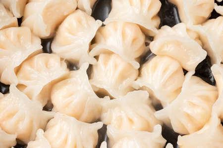 Traditional Asian Prawn or shrimp dumplings hakau, ha kauw or har gow. Served with cabbage, carrot salad and soy and sweet chilli sauceの写真素材