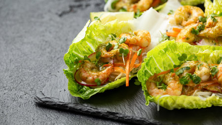 Lettuce wraps loaded with Spicy prawn, shrimp and rice vermicelli noodles, Asian style finger party foodの写真素材