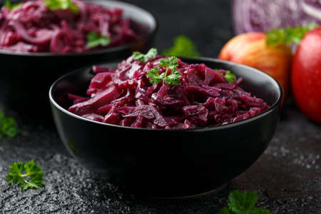 Braised Red Cabbage with apples and redcurrant in black bowlの写真素材
