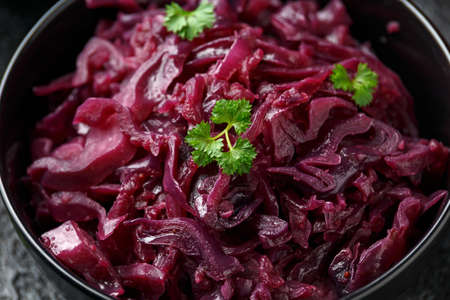 Braised Red Cabbage with apples and redcurrant in black bowlの写真素材