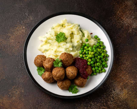 Homemade Swedish Meatballs with cranberry relish Sauce, potato mash and peasの写真素材