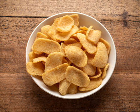 Crispy Prawn Crackers in white bowl on wooden table