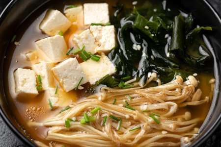 Rich miso soup with enoki mushrooms, wakame seaweed and tofu, vegetarian, vegan Asian food.の写真素材