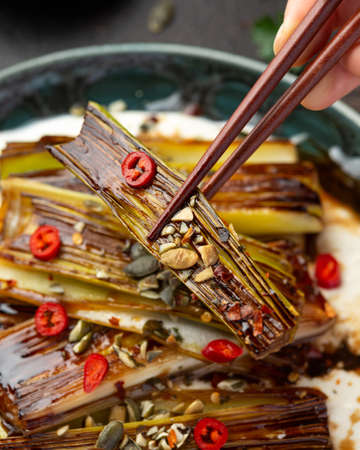 Sweet and sour braised leeks over whipped feta cheese, vegetarian vegan summer Asian style food...