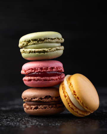 Homemade macarons chocolate, pistachio, lemon and raspberry french sandwich cookiesの写真素材