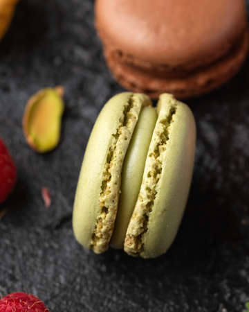Homemade macarons chocolate, pistachio, lemon and raspberry french sandwich cookiesの写真素材