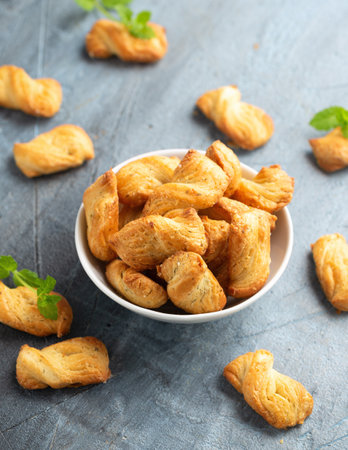 Mini Cheese Twist Sticks with cheddar cheese in white bowl. party food snacksの写真素材