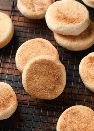 Homemade toasted English Muffins on cooling rackの写真素材