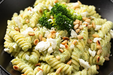 Creamy broccoli feta cheese pasta with pine nuts. Healthy foodの写真素材