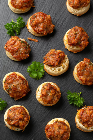Cheese and BBQ sauce beans on mini crumpets. Party Finger food concept.