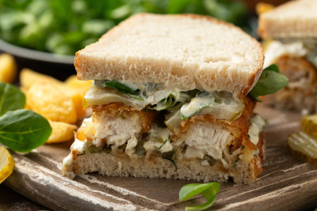 Fish Finger Sandwich on wooden board with potato friesの写真素材