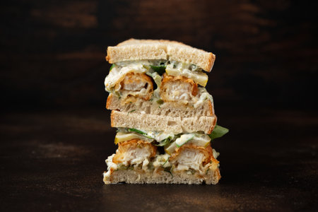 Fish Finger Sandwich on wooden board with potato friesの写真素材