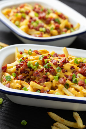 Crispy French fries loaded with bacon, cheese sauce and spring onionの写真素材