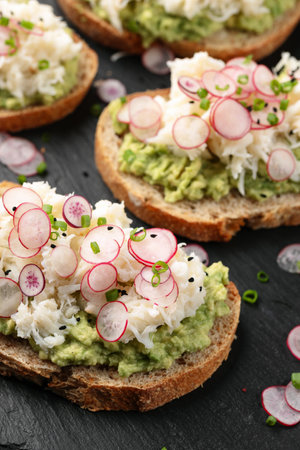 Crab meat and smashed avocado and radishes Sourdough bread toastsの写真素材
