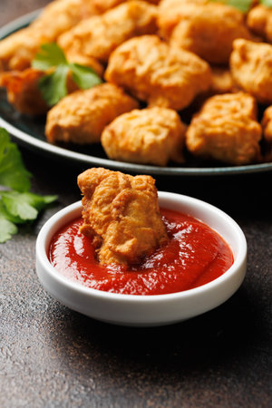 Homemade crispy fried chicken nuggets served with ketchup.の写真素材