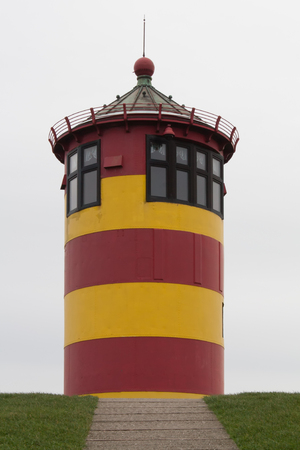 A lighthouse on a dykeの写真素材