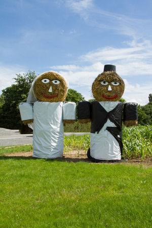 Wedding couple with foil decorated straw baleの写真素材