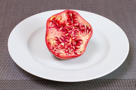 A pomegranate sliced on a plateの写真素材