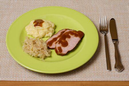 smoked pork chop with sauerkraut and potato pureeの写真素材