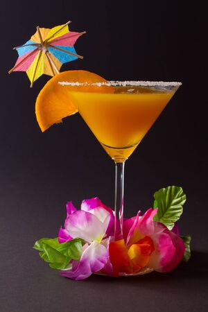 Orange cocktail with orange slice on edgeの写真素材