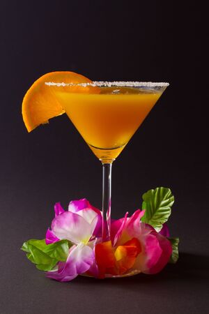 Orange cocktail with orange slice on edgeの写真素材
