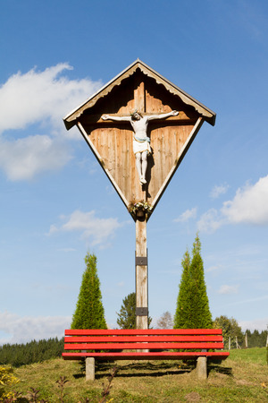 crucifix with a bench underneathの写真素材