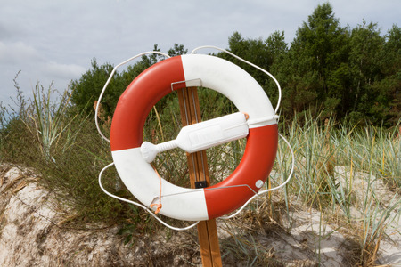 A lifebelt
 hangs on a wooden board on the beachの写真素材