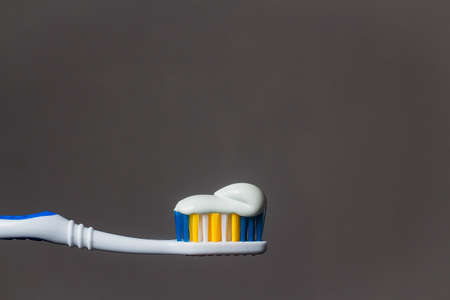 toothbrush with toothpaste isolated on grey background.の写真素材