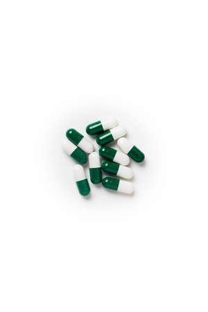 white-green pill capsules isolated on white background, medical concept, copy space, top view.