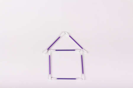 house of purple cotton buds on a white background, hygiene concept, copy spaceの写真素材