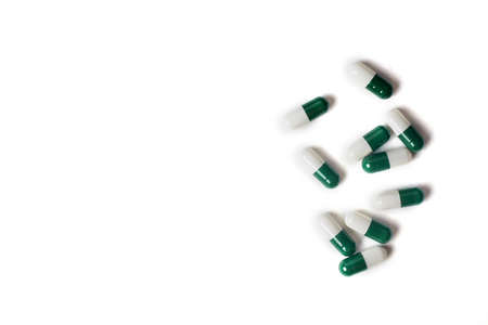 white-green pill capsules isolated on white background, medical concept, copy space, top view.