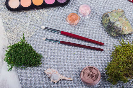 Beautiful composition: professional make-up brushes and tools, decorative elements.