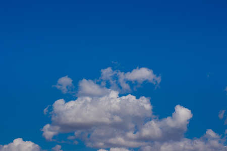 White cumulus clouds in a blue sky