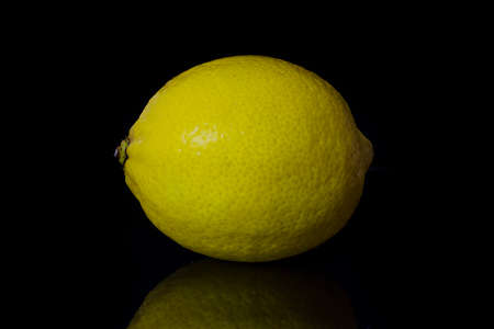 lemon on black background with reflection