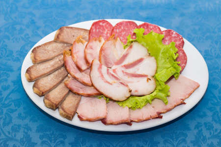 Mixture of sliced meat, sausage and ham, restaurant table