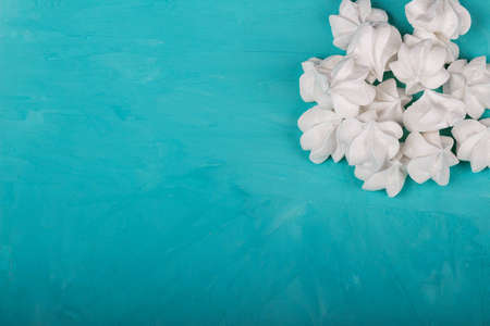 delicious meringue on turquoise background, sweetnessの写真素材